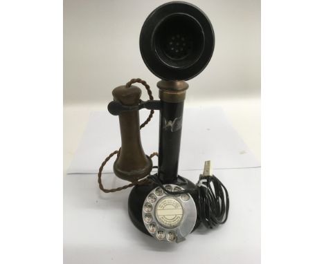 A metal candlestick telephone