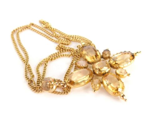 A citrine crucifix pendant, the pendant set with oval cut and asher cut citrines and topazes, each in a claw setting with fou