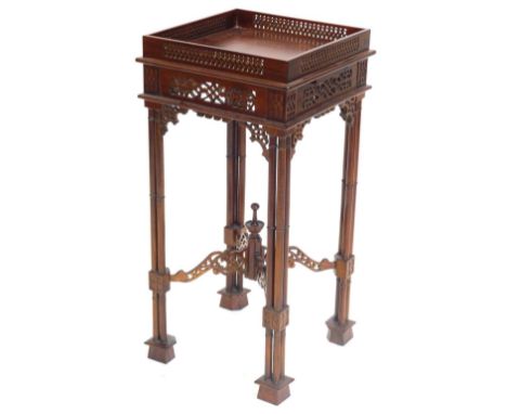 A mahogany urn stand in Chippendale style, the square top with a pierced gallery, above a fret work frieze, on cluster column