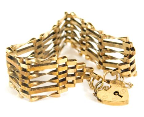 A 9ct gold six strand gate bracelet, with heart shaped clasp marked 375, 18cm long, 12.4g.