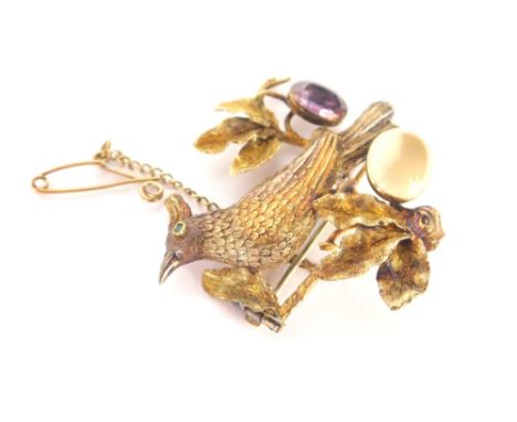 A Victorian/Edwardian bar brooch, formed as a bird with moonstone and amethyst, and an emerald eye with flower and leaf detai