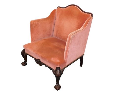An early 20thC mahogany armchair, in Chippendale style, with mahogany show frame, upholstered in pink upholstery, above a she