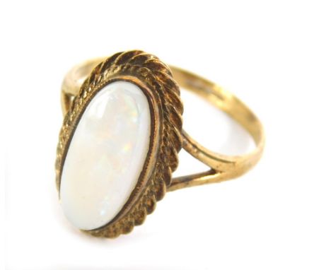 A dress ring, set with oval opal on part pierced shank, indistinctly marked, size R.