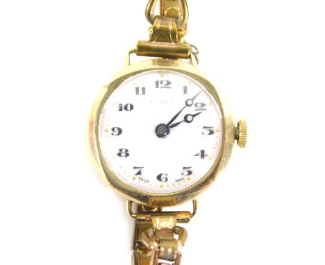 An early 20hC 9ct gold cased ladies wristwatch, with white enamel numeric dial, with gold markers, 2cm wide, on an expanding 