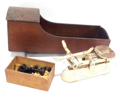 An early 20thC crib, 23cm high, a partially boxed set of Superior Quality chess pieces, and a metal table scale. (3) 