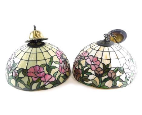 A pair of Tiffany style lamp shades, in pink, cream and green, with metal mounts, 35cm wide. (2)