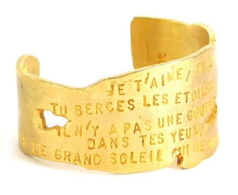 A 20thC Poeme Lancome Je T'iame bangle, 7cm wide.