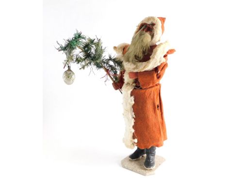 A clockwork Father Christmas automaton, in standing pose, with papier mache face, flowing beard, red velvet dress, and black 