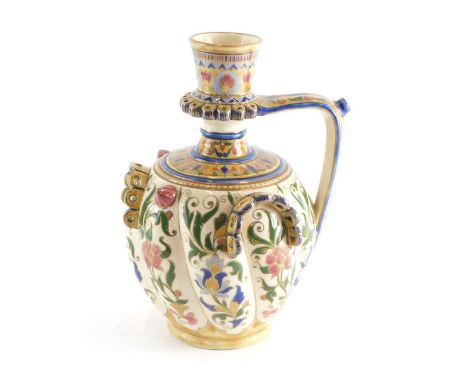 A late 19thC Zsolnay Pecs pottery jug, the bulbous ribbed body hand painted with flowers with gilt highlights, raised with ot