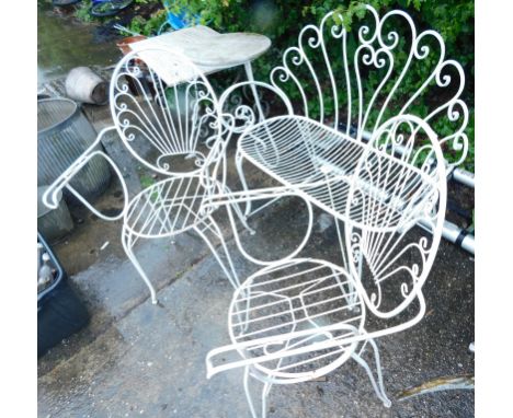 A suite of three white painted wrought iron garden set, comprising a two seat sofa with fan shaped back and two associated ar