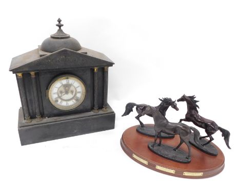 A 19thC slate mantel clock, of architectural design with 12cm diameter dial, flanked by four columns and surmounted by a dome