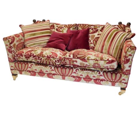 A Duresta Knowle type sofa, upholstered in red and gold patterned fabric, on square tapering legs with brass castors, 195cm w