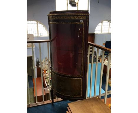 A Louis XV style standing corner cabinet with bow front and glazed doors