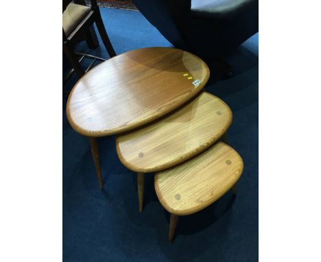 A nest of three Ercol Golden Dawn 'Pebble' tables