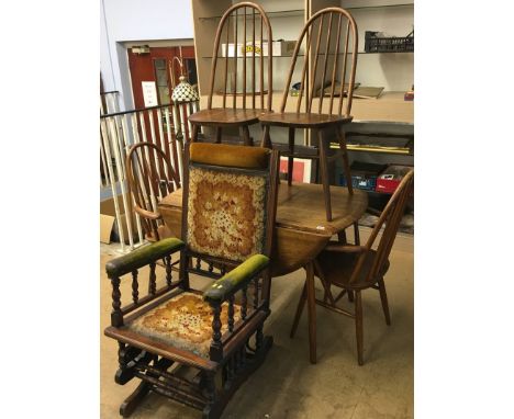 An Ercol table, four chairs and an American rocking chair