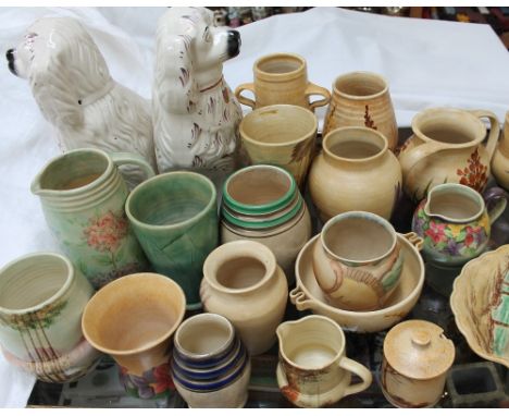 A collection of E Radford floral painted pottery together with a pair of Staffordshire spaniels