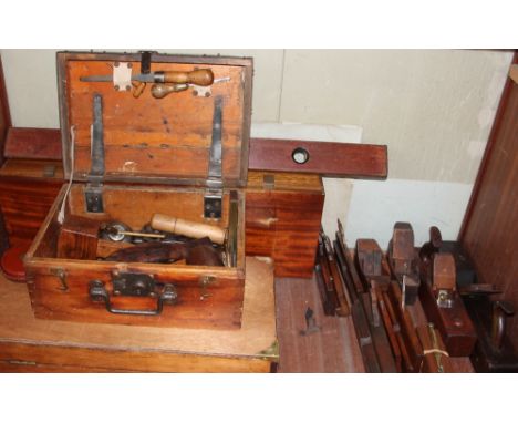 A box of wood planes, together with two wooden tool boxes and tools, spirit level and gun box