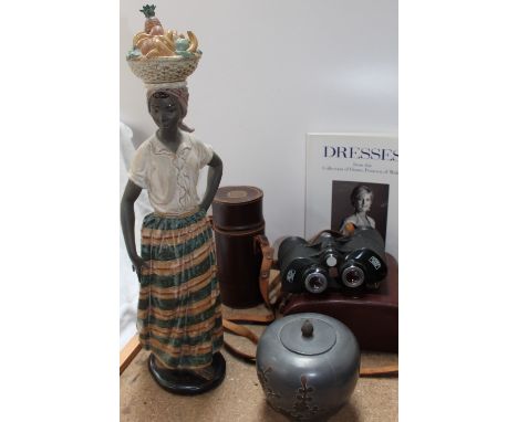 A Nao figure of an African lady, together with a pair of Carl Zeiss Octarem 8 x 50B binoculars, Christies catalogue of Diana'