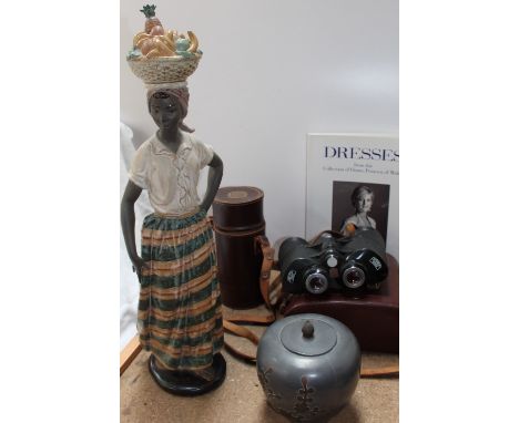 A Nao figure of an African lady, together with a pair of Carl Zeiss Octarem 8 x 50B binoculars, Christies catalogue of Diana'