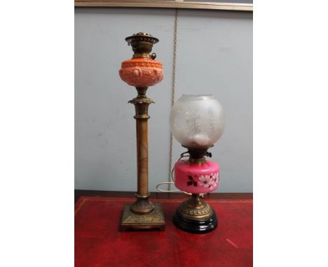 A glass, onyx, and brass oil lamp together with another oil lamp converted to electricity