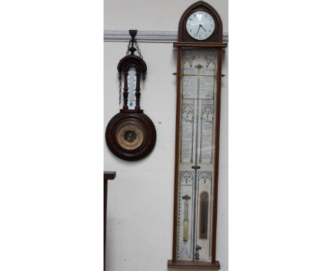 An Admiral Fitzroy barometer with a clock to the apex, by Comitti of London, with a mercury tube, alcohol thermometer, and at