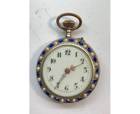 Antique silver and enamel fob watch set with seed pearls and blue stones on bezel with enamel back watch ticks and stops no w