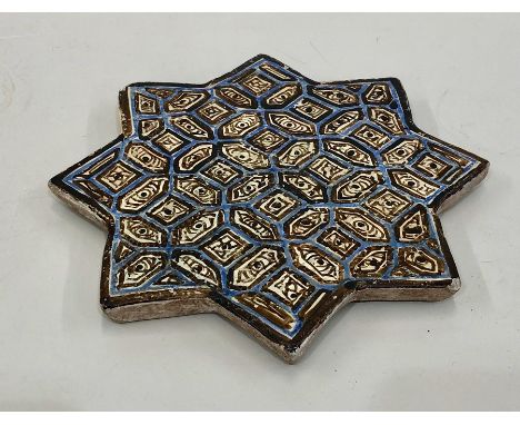 Antique star shaped Persian tile measures approx 21cm dia 