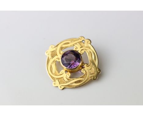 Victorian amethyst 9ct gold brooch, the round mixed cut amethyst diameter approx 8mm, collet setting, entwined scroll design 