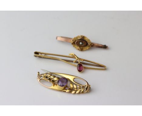 Three Edwardian 9ct gold brooches comprising pink tourmaline sprig brooch; amethyst stray brooch and seed pearl target bar br