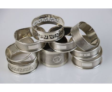 Nine silver napkin rings to include a set of five, engine turned decoration, blank rectangular cartouche, makers WI Broadway,