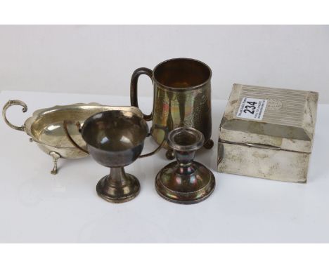 A collection of fully hallmarked sterling silver collectables to include Cigarette box, Trophy, Cup, sauce boat and a candles