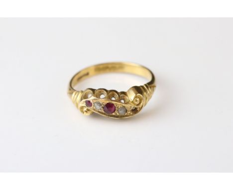 Early 20th century ruby and diamond 18ct yellow gold scroll head ring, two small round mixed cut rubies and two small rose cu