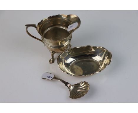 A small collection of fully hallmarked sterling silver items to include a pin dish, cream jug and a Georgian scalloped caddy 