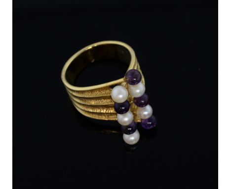 Stuart Devlin amethyst and pearl dress ring, set with two lines of alternating pearl and amethyst beads to tapered textured s