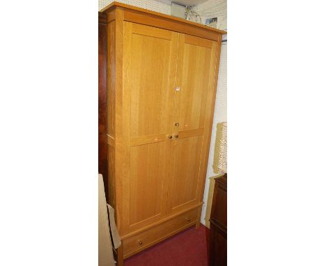 A contemporary light oak double door wardrobe having single long lower drawer, width 105cm