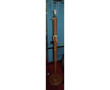 An Eastern relief carved teak standard lamp