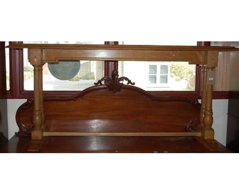 An early 20th century light oak long altar table, the moulded top raised on turned and square cut end supports united by cent