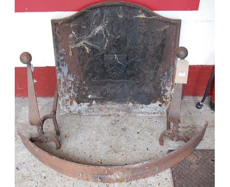 A cast iron arch topped fire-back; together with a pair of cast iron Art Nouveau andirons, and a curved fender (4)