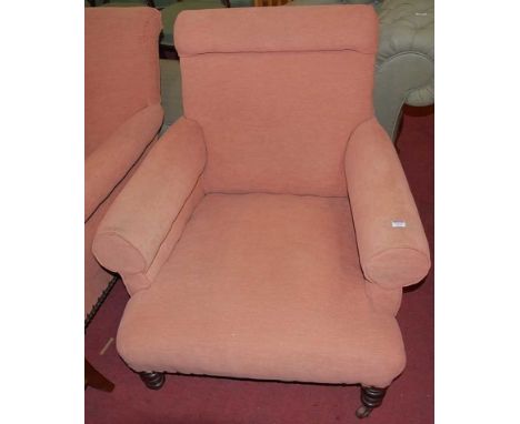 An Edwardian walnut framed and upholstered armchair, raised on ring turned forelegs, w.85cm