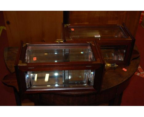 A pair of reproduction mahogany and brass mounted wall-mounted lamp cases, each having bevelled doors and mirrored interior