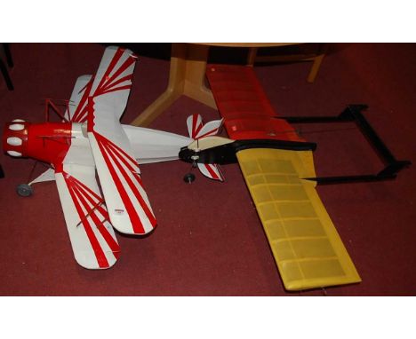 A balsa wood homemade model bi-plane, painted in red and white; together with a single wingspan home-built plane (2)Condition