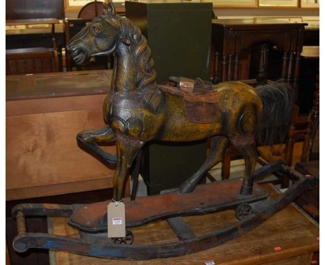 An Eastern stained and carved hardwood rocking horse raised on integral bowed stand, length 122.5cm