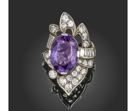 An amethyst and diamond ring, claw-set with an oval amethyst, within an asymmetrical border pavé-set with brilliant-cut diamo
