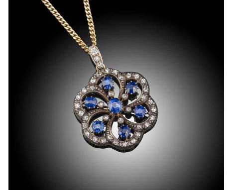 A late 19th century sapphire and diamond pendant, set with graduated cushion-shaped sapphires within diamond-set hexafoil set