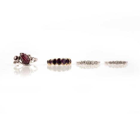 A group of four rings, comprising: an amethyst eight stone ring, in closed-back yellow gold setting, size M, two diamond five