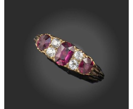 A late 19th century ruby and diamond half-hoop ring, set with graduated cushion-shaped rubies separated with pairs of old cir