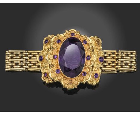 A 19th century amethyst and gold bangle, mid 19th century and later, the oval amethyst within repoussé gold scroll mount set 