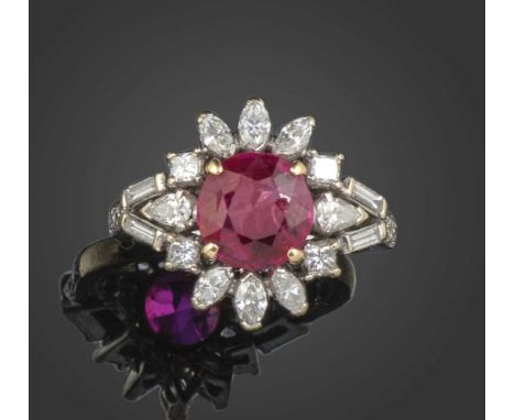 A ruby and diamond cluster ring, the cushion-shaped ruby weighing approximately 1.80cts, set within a surround of diamonds in