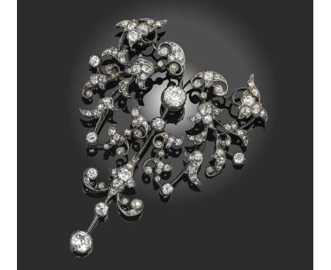 A late 19th century diamond brooch, centring on an old cushion-shaped diamond within stylised foliate surround set with diamo