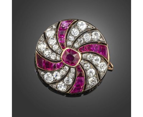 A late 19th century ruby and diamond brooch, set with a central cushion-shaped ruby within radiating lines of calibré-cut rub